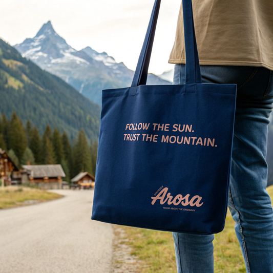 Discover Arosa Tote Bag, organic cotton tote with ‘Follow the Sun. Trust the Mountain.’ design, screenprinted in Arosa, Switzerland